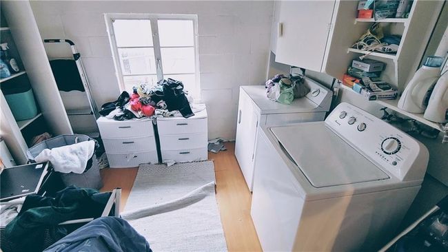 Washroom with washing machine and clothes dryer and light wood finished floors | Image 14