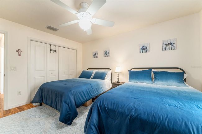 Rear guest room closet has custom shelving. Furnishings are optional. | Image 24
