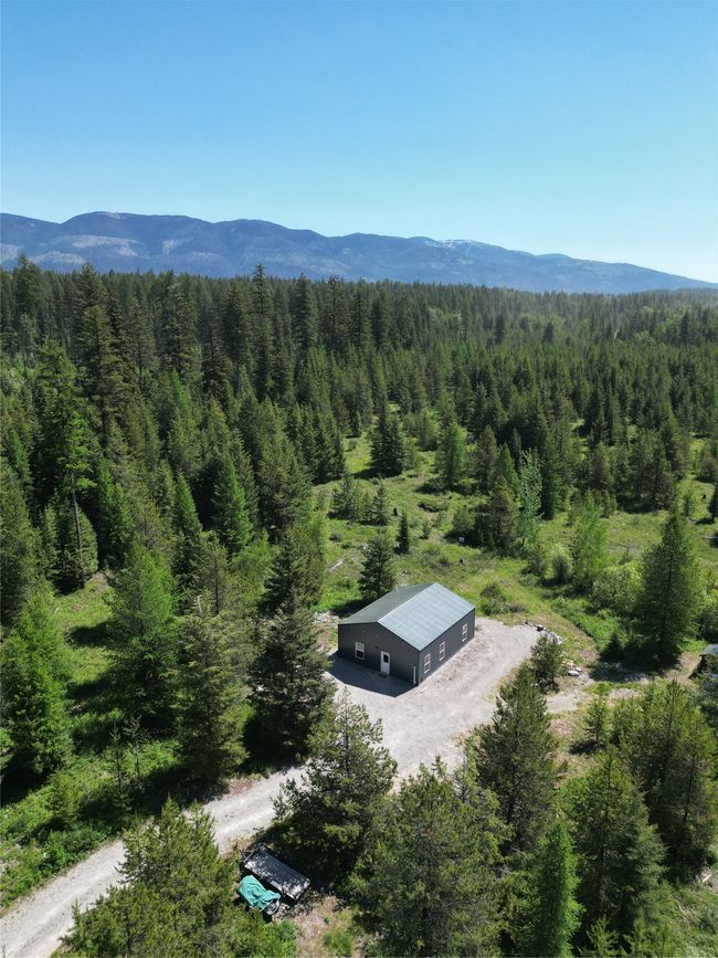 Aerial view of property and surrounding area with a forest and a mountain backdrop | Image 22