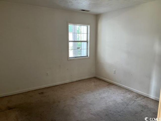 Carpeted empty room with baseboards and a textured ceiling | Image 6