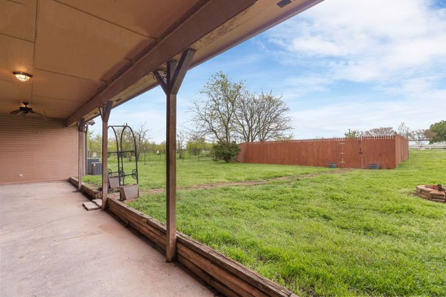 View of yard with central AC unit, a patio, and fence | Image 6