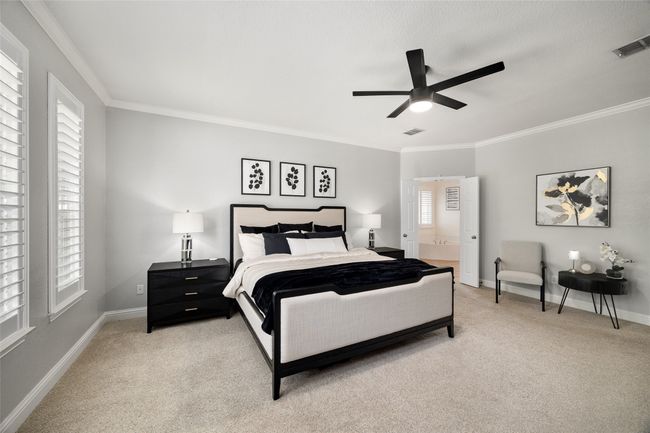 Bedroom featuring baseboards, light carpet, crown molding, and visible vents | Image 15