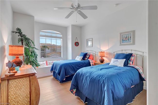 Guest Bedroom featuring light wood-type flooring and ceiling fan | Image 18