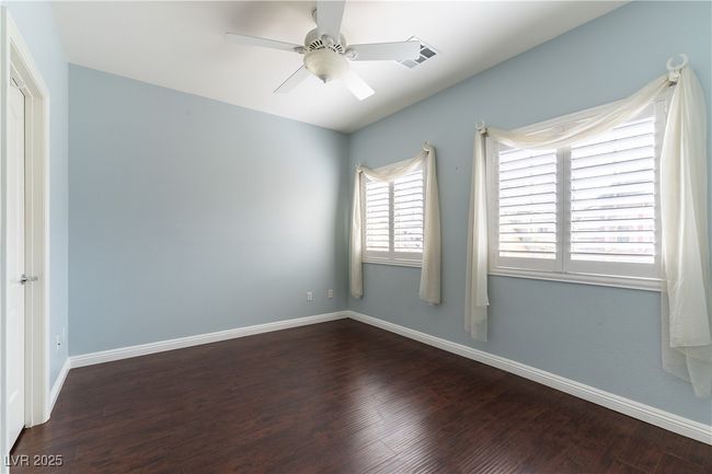 Bedroom featuring a ceiling fan, baseboards, and wood finished floors | Image 20