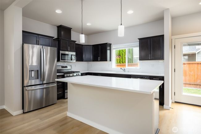Kitchen with gas range, dishwasher, micro hood, disposal and refrigerator. | Image 8