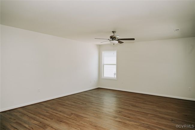Spare room featuring ceiling fan and dark hardwood / wood-style flooring | Image 5