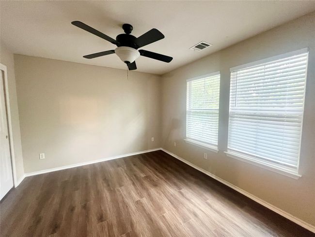 Spare room with wood look finished floors, and a ceiling fan | Image 15