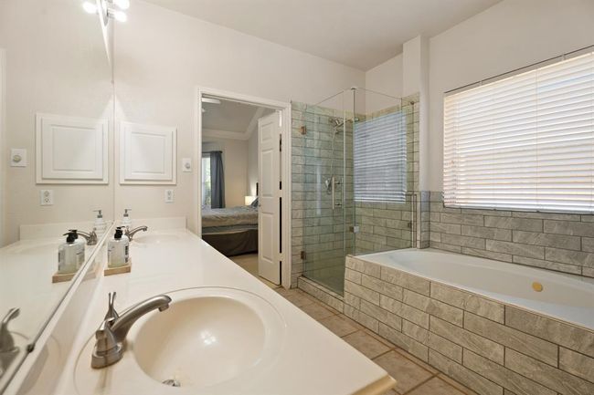 Beautiful glass shower door and double sinks with updated hardware. | Image 13