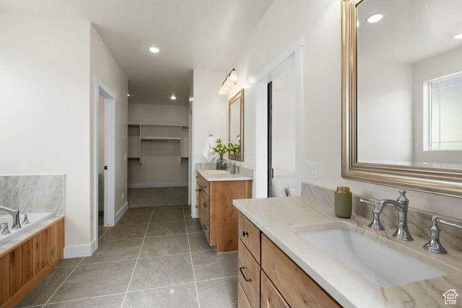 Full bath with recessed lighting, two vanities, a garden tub, and a sink | Image 25