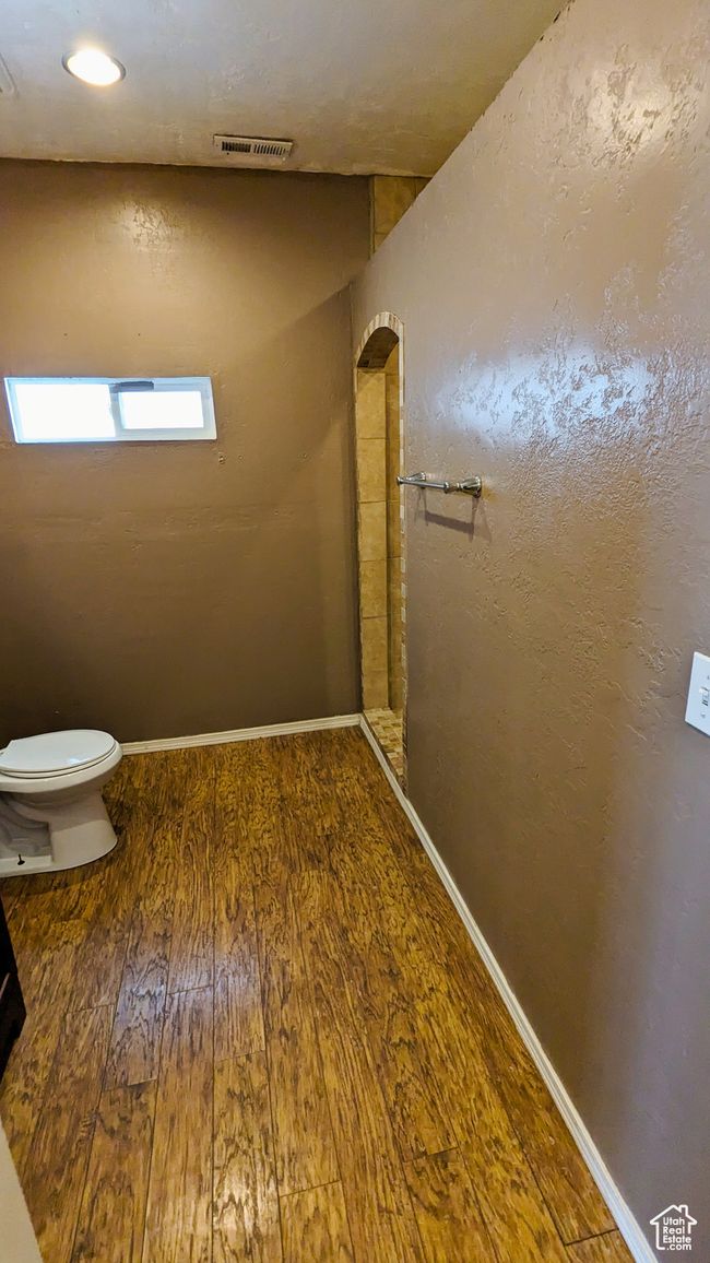 Bathroom with wood-type flooring and toilet | Image 38