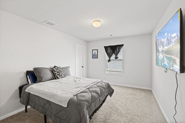 Carpeted bedroom featuring baseboards and visible vents | Image 23