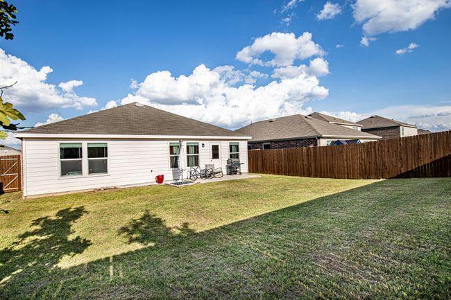 Back of property featuring a patio area, a fenced backyard, and a shingled roof | Image 30