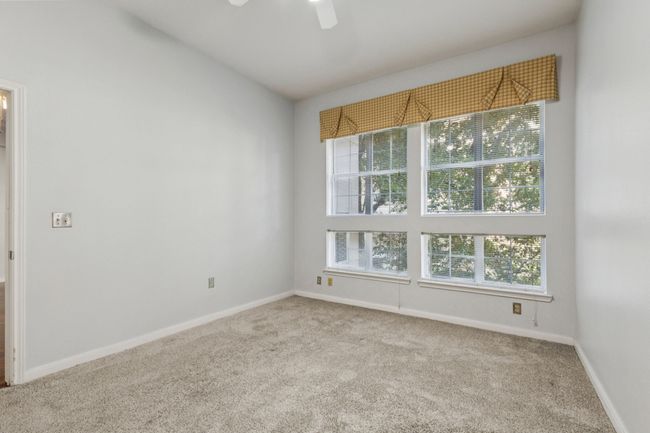 Carpeted empty room with baseboards and ceiling fan | Image 20