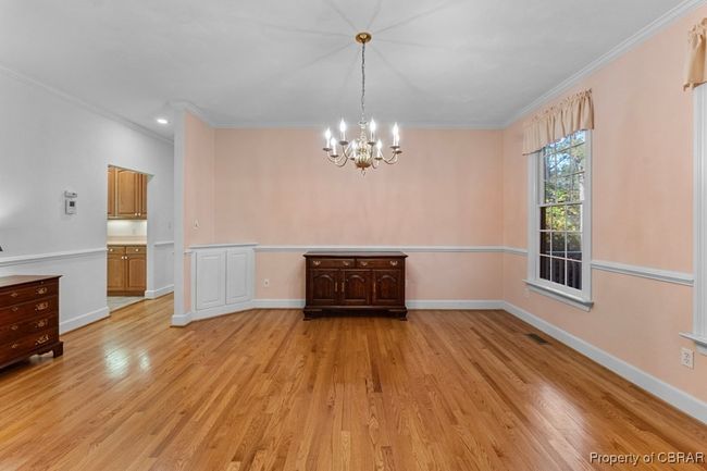 Unfurnished dining area with a chandelier, ornamental molding, and light wood finished floors | Image 19