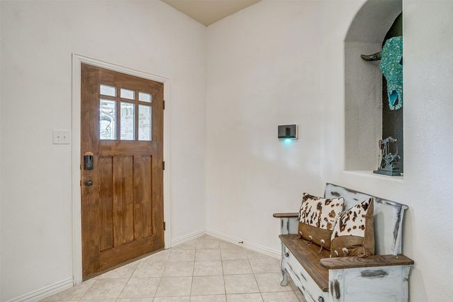 Foyer featuring light tile patterned floors and baseboards | Image 8
