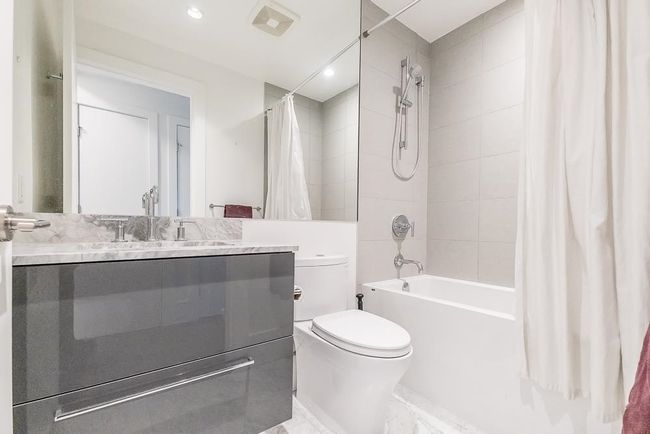 Bathroom with shower / bath combo with shower curtain, toilet, and vanity | Image 26