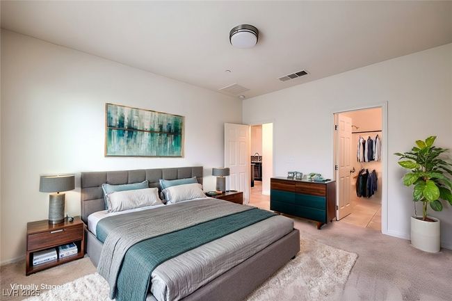 Bedroom with light carpet, baseboards, a spacious closet, and visible vents **VIRTUALLY STAGED** | Image 6