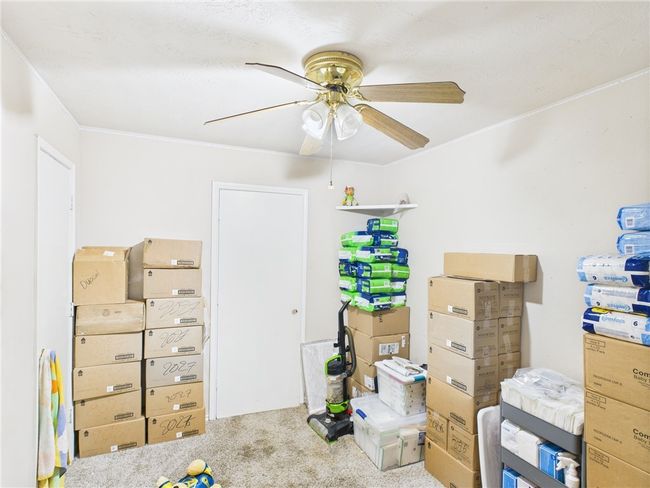 Bedroom with carpet, crown molding, and ceiling fan | Image 6