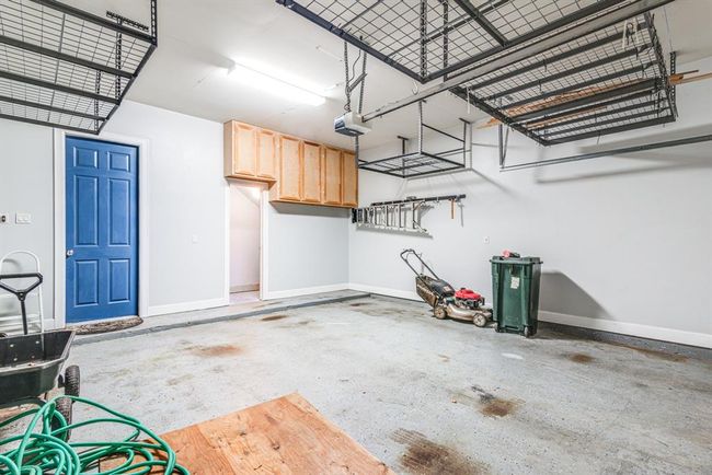 Two car garage has additional storage room, cabinetry and extra storage racks for various water toys and decorations. | Image 33