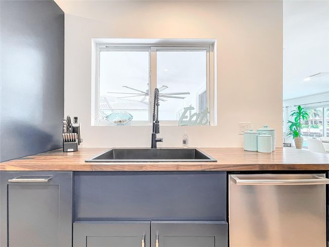 Kitchen window faces courtyard dining table | Image 16