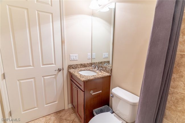 Bathroom featuring toilet, tile patterned floors, and vanity | Image 22