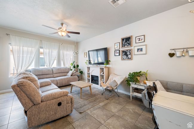 Living room with a ceiling fan | Image 8