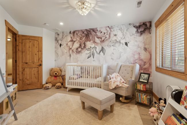 Bedroom with recessed lighting, wood finished floors, and an accent wall | Image 32