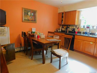 Dining room Apt. #1, with baseboard heating and sink | Image 3