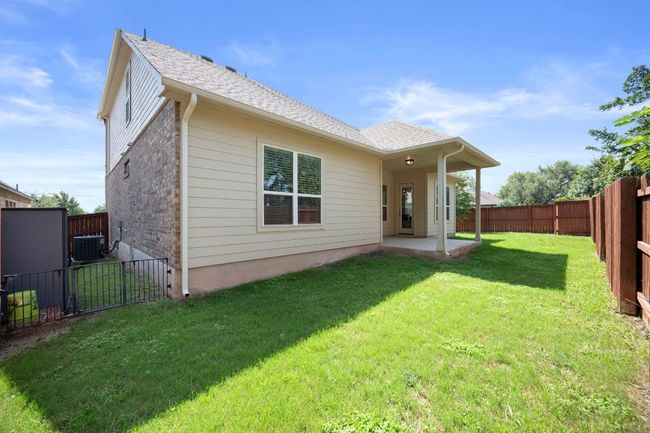 Back of property featuring cooling unit, a patio, and roof with shingles | Image 32