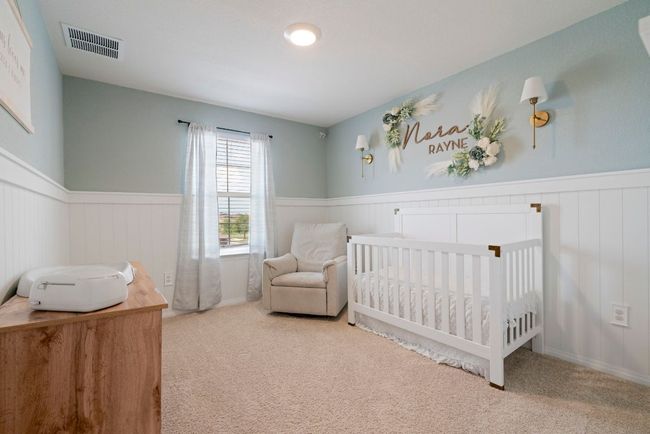 Carpeted bedroom with a wainscoted wall and a crib | Image 28