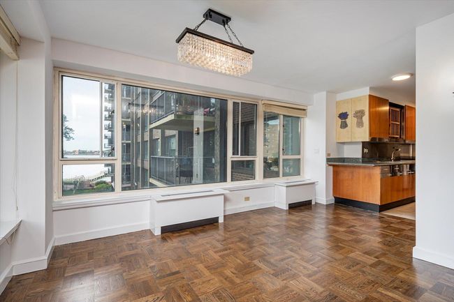 Unfurnished dining area featuring baseboards, a chandelier, a sink, and recessed lighting | Image 8