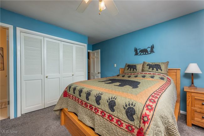 Bedroom with a closet, ceiling fan, and carpet | Image 28