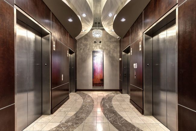Corridor with inlaid floor details, elevator, recessed lighting, and light marble finish floors | Image 30