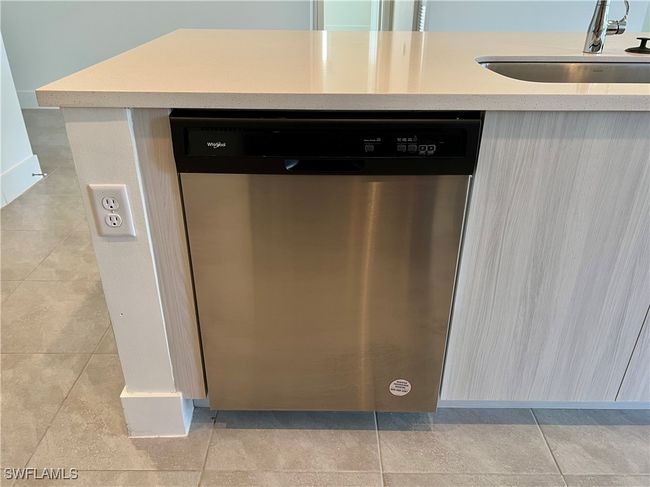 Room details with stainless steel dishwasher, sink, and light tile patterned flooring | Image 11