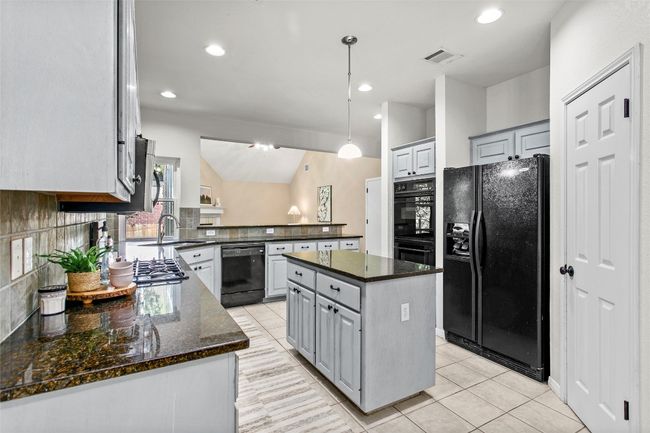 The kitchen is open to the living room and breakfast area | Image 17