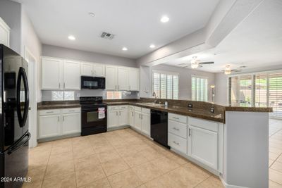 Kitchen with Granite Counters, White Cabinets & Smooth Top Range! | Image 3