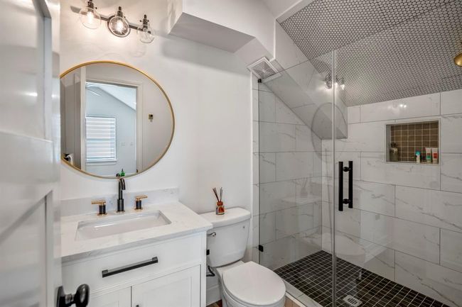 The upstairs full bathroom features a walk-in shower, updated fixtures, and a clean, modern design. | Image 33