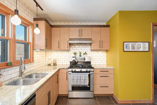 Subway tile & stylish light fixtures punctuate this kitchen | Image 15