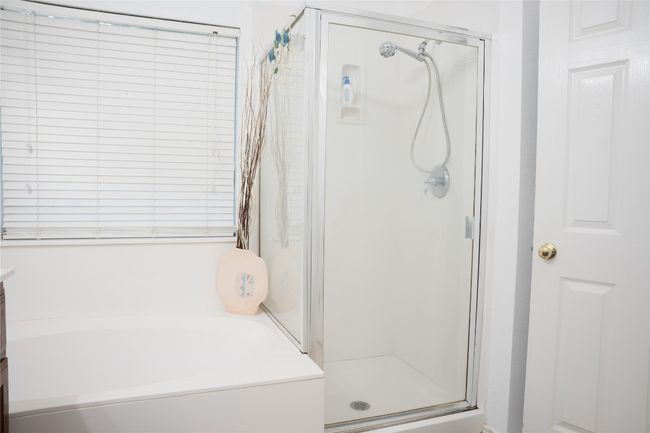 Bathroom with a stall shower and a garden tub | Image 16