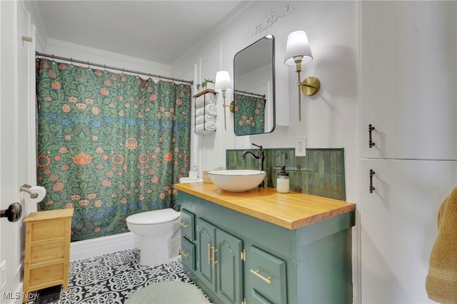 Bathroom featuring vanity, tile patterned flooring, and a shower with shower curtain | Image 16