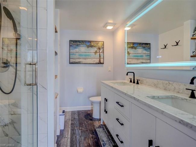 OWNER'S SUITE BATH. MARBLE-TOPPED DUAL SINK VANITY. ANTI-FOG BACK-LIT MIRROR. | Image 25