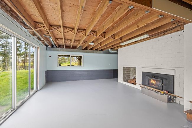 Below grade area with a warm lit fireplace | Image 42