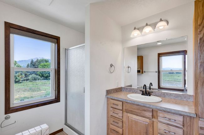 Bathroom, plenty of natural light, a shower stall, and vanity | Image 36