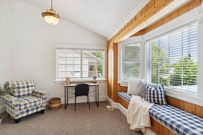 Sitting area featuring carpet, desk, plenty of natural light, lofted ceiling, ornamental molding, and baseboards | Image 13