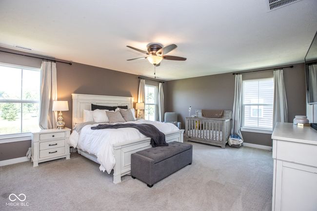 bedroom featuring light carpet and a ceiling fan | Image 14