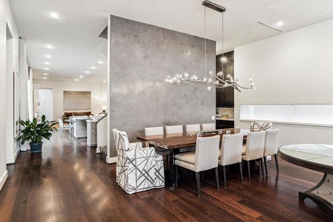 A side hallway from the Front Foyer facilitates direct access to the formal Powder Room, Garage entry door, front Staircase, Elevator and finally opens to the rear of the home with its Wet Bar, KItchen, Breakfast area and spacious Family Room. | Image 7