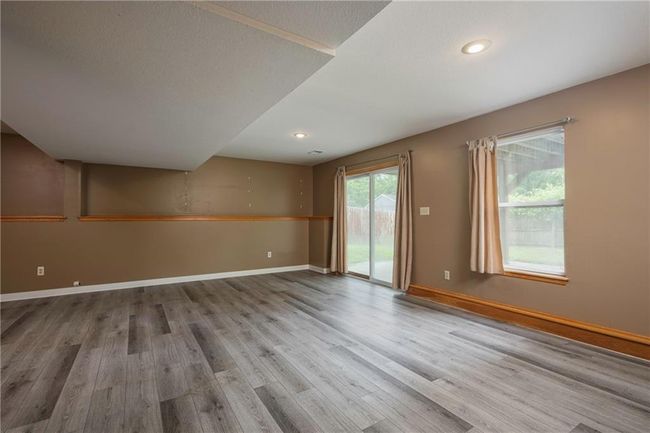 Spare room featuring wood finished floors, baseboards, and recessed lighting | Image 27