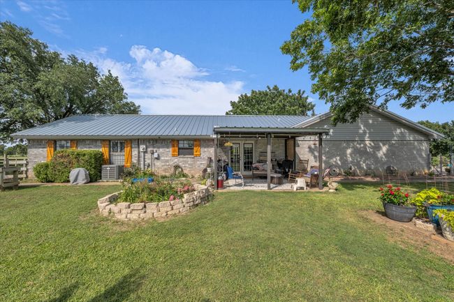 Rear view of property with brick siding, a yard, and a patio area | Image 21