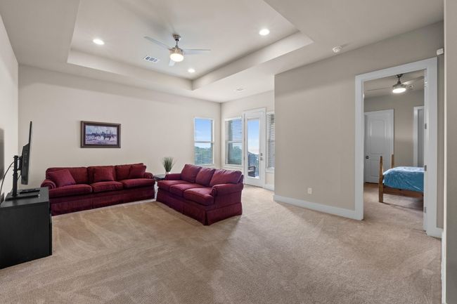 Living room featuring recessed lighting, a raised ceiling, visible vents, light carpet, and ceiling fan | Image 29