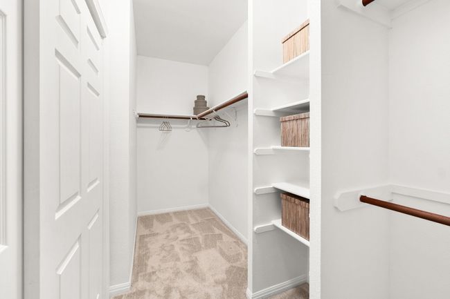 Walk in closet with carpet floors | Image 19